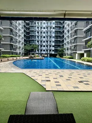 a large swimming pool in the middle of a building at Mall of Asia shore 3 Tower 21661 Residence in Manila