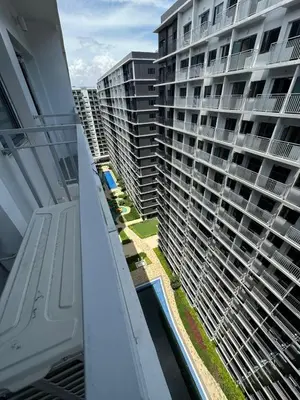 a view of a large apartment building from a balcony at Mall of Asia shore 3 Tower 21661 Residence in Manila