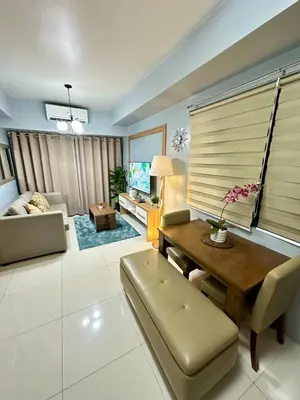 a living room with a table and a couch at Mall of Asia shore 3 Tower 21661 Residence in Manila