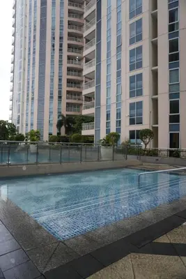 a swimming pool in front of two tall buildings at Modern Rustic Pet Friendly Condo in Mckinley Hill BGC in Manila