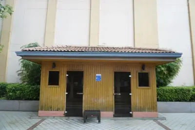 a wooden building with a bench in front of it at Modern Rustic Pet Friendly Condo in Mckinley Hill BGC in Manila