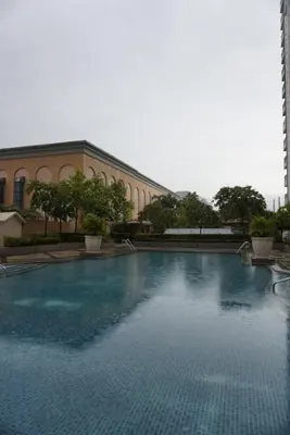 a large pool of water in front of a building at Modern Rustic Pet Friendly Condo in Mckinley Hill BGC in Manila