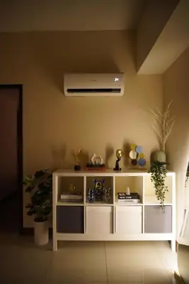 a white shelf in a living room with a ceiling at Modern Rustic Pet Friendly Condo in Mckinley Hill BGC in Manila