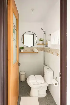 a bathroom with a white toilet and a mirror at Islana Stay Rm A for 1pax only in Imus