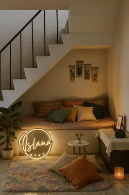 a bedroom with a bed under a staircase at Islana Stay Rm A for 1pax only in Imus