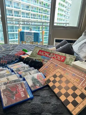 a table with games and board games on it at Condo near airport with PS4 and Parking in Manila