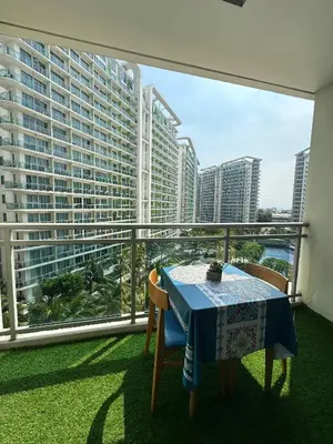 a balcony with a table and a view of a city at Condo near airport with PS4 and Parking in Manila