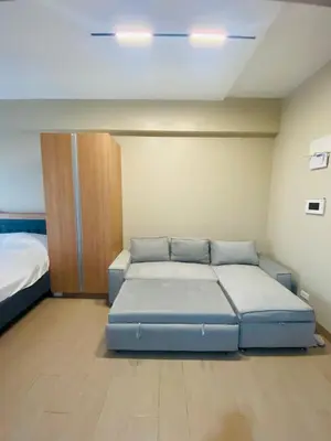 a bedroom with a blue bed at One Eastwood with mountain view in Manila
