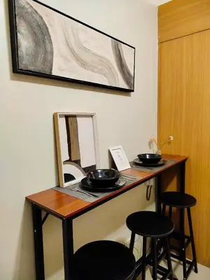 a table with two bowls on it with two stools at Classy and Cozy Staycation near MOA in Manila