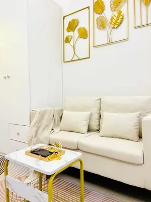 a living room with a white couch and a table at Bai Labi Luxury Lounge in Manila