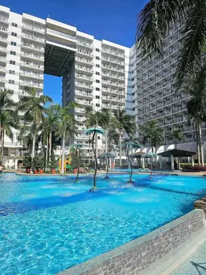 a large swimming pool in front of a large building at Bai Labi Luxury Lounge in Manila