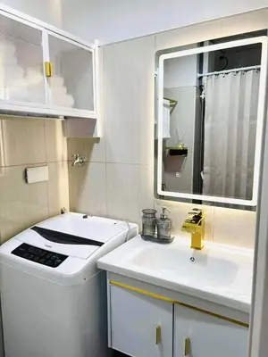 a small bathroom with a sink and a mirror at Bai Labi Luxury Lounge in Manila