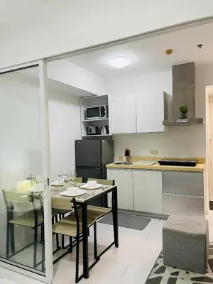 a kitchen and dining room with a table and chairs at B&T Azure Staycation - Parañaque in Manila