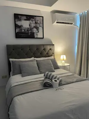 a bedroom with a large white bed with a blanket at B&T Azure Staycation - Parañaque in Manila
