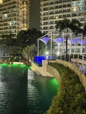 a bridge over a body of water at night at B&T Azure Staycation - Parañaque in Manila