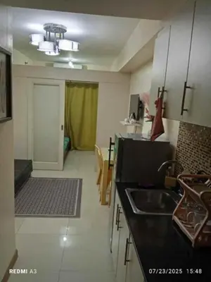 a kitchen with a sink and a counter top at The Tenth Balcony in Manila