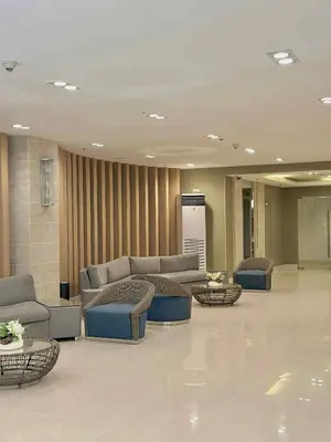 a lobby with couches and tables in a building at The Tenth Balcony in Manila
