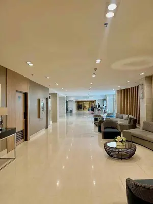 a large lobby with couches and tables in a building at The Tenth Balcony in Manila