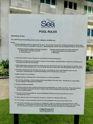 a sign in the grass in front of a building at The Tenth Balcony in Manila