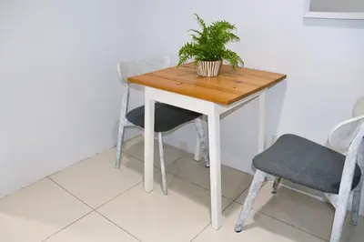 a table and chairs with a potted plant on it at Niu Ohana Ortigas Apartments and Residences in Manila