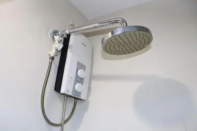 a shower with a light on a wall at Niu Ohana Ortigas Apartments and Residences in Manila