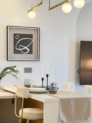a white dining room with a white table and chairs at Casa Elisae l Venice Grand Canal Mall Access in Manila