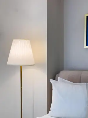 a lamp sitting next to a bed with a pillow at Casa Elisae l Venice Grand Canal Mall Access in Manila