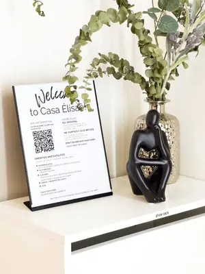 a sign on a shelf next to a vase at Casa Elisae l Venice Grand Canal Mall Access in Manila