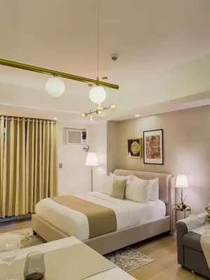 a bedroom with a large bed and a couch at Casa Elisae l Venice Grand Canal Mall Access in Manila