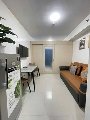 a living room with a couch and a table at AilynSea residence staycation in Manila