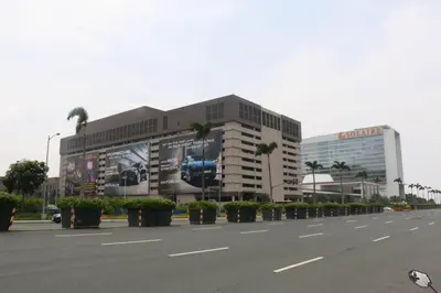 a large building with palm trees on the side of a street at 349B by Premiere Haven Shell Residences in Manila