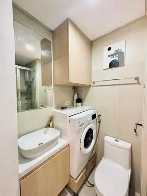 a bathroom with a washing machine and a sink at Mujihomes - 1BR SMDC Fame Residences Mandaluyong in Manila