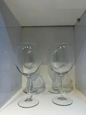 three wine glasses sitting on top of a shelf at Mujihomes - 1BR SMDC Fame Residences Mandaluyong in Manila