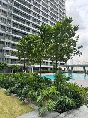 a large apartment building with a pool and trees at Mujihomes - 1BR SMDC Fame Residences Mandaluyong in Manila