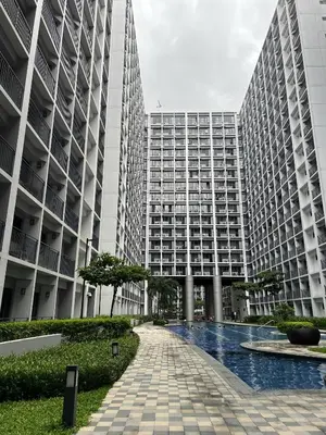 two tall buildings with a walkway in front of them at Staycation near MOA, SMX Convention, DFA & NAIA, in Manila