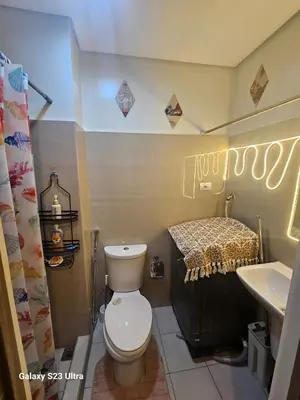 a bathroom with a toilet and a sink at Staycation near MOA, SMX Convention, DFA & NAIA, in Manila