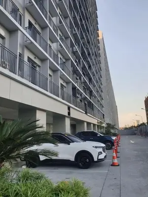 a white car parked in front of a building at Shore 3 Residences Condo with Netflix and Wifi in Manila