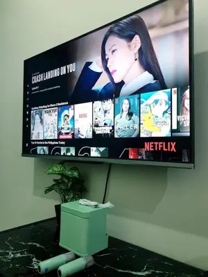 a flat screen tv hanging on a wall at Shore 3 Residences Condo with Netflix and Wifi in Manila