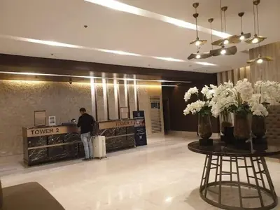 a man standing at the counter of a flower shop at Shore 3 Residences Condo with Netflix and Wifi in Manila