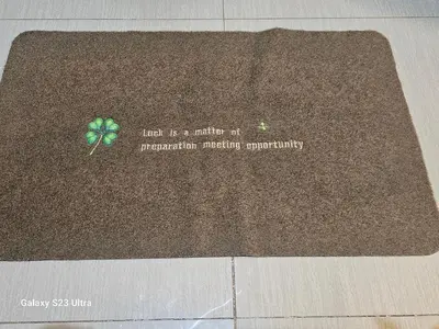 a brown rug with a green clover on it at Staycation near MOA, SMX Convention, DFA, NAIA in Manila