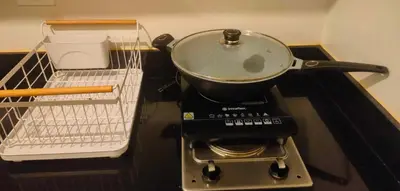 a pot on top of a stove with a basket at Staycation near MOA, SMX Convention, DFA, NAIA in Manila