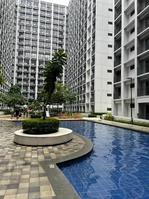 a swimming pool in front of two tall buildings at Staycation near MOA, SMX Convention, DFA, NAIA in Manila