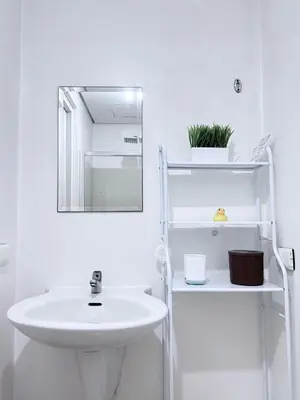 a white bathroom with a sink and a mirror at SMDC Light Residences - Studio Condo Unit in Manila