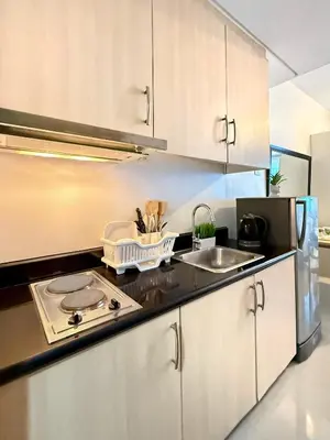 a kitchen with a stove top and a sink at SMDC Light Residences - Studio Condo Unit in Manila