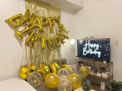 a room with a bunch of gold helium balloons at SMDC Light Residences - Studio Condo Unit in Manila