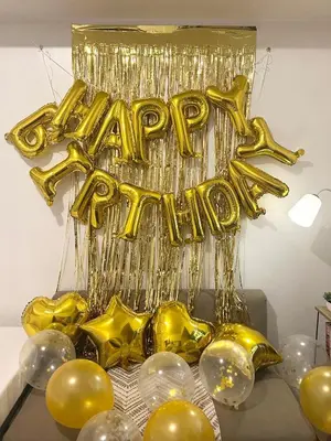 a bunch of gold balloons and a happy birthday sign at SMDC Light Residences - Studio Condo Unit in Manila