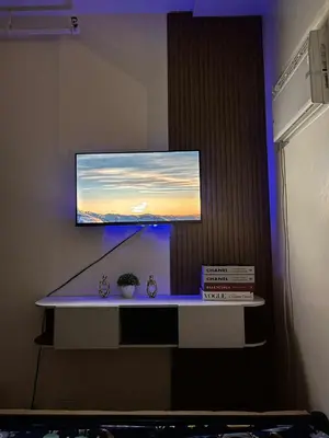a flat screen tv on a wall in a room at Mars Condo Unit in Manila