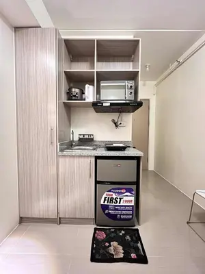 a kitchen with a stove and a microwave at Mars Condo Unit in Manila