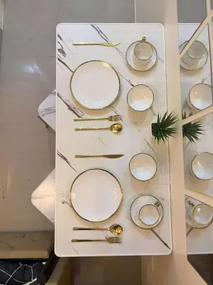 a table with plates and utensils on a shelf at Mars Condo Unit in Manila