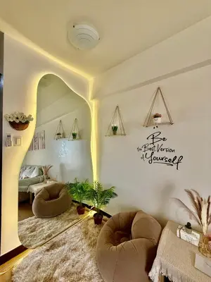 a living room with two ottomans and a bed at YourSafeHaven in Manila